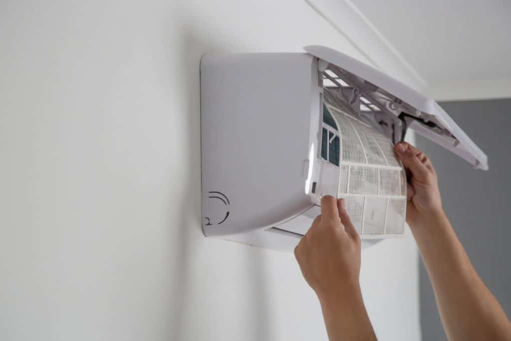 putting new clean air filter on air conditioner